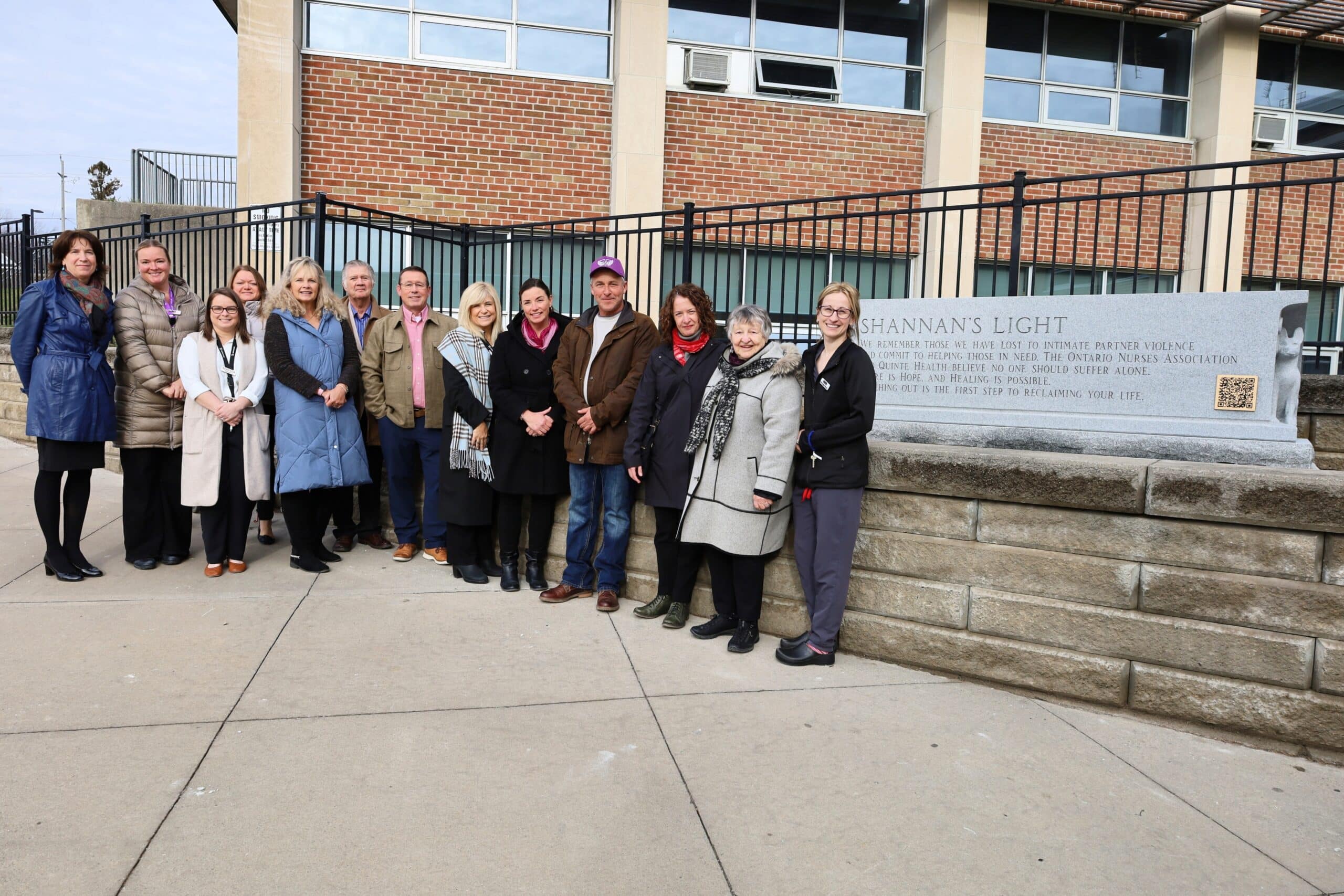 Members of Shannan Hickey's family, the Trenton Memorial Hospital Foundation, and Quinte Health beside the Shannan's Light monument outside Belleville General Hospital