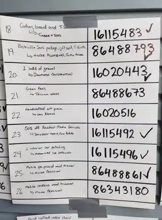 Handwritten prize board listing tournament prizes 18 through 26