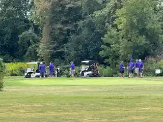 Golfers and carts on the tournament course