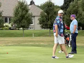 Golfers walking together near the green