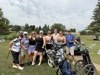 Golfers posing together with their carts
