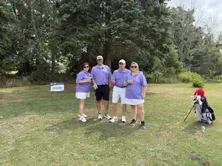 Tournament foursome posing on the course