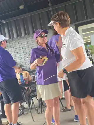Tournament volunteers talking under the pavilion
