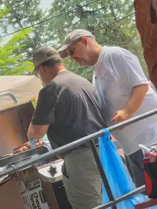 Volunteers grilling food at the tournament