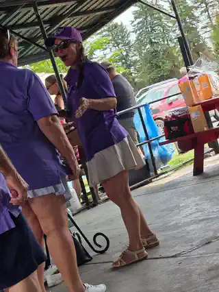 Volunteer helping at the tournament raffle table