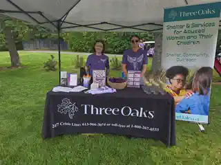 Three Oaks Foundation volunteers at the tournament booth