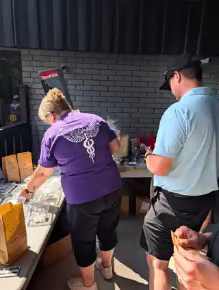 Guests at the 2nd Annual tournament raffle and prize table