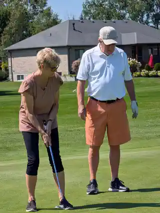 Two golfers together on the green at the 2nd Annual memorial tournament
