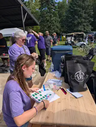 Guests and volunteers gathered at the tournament welcome table